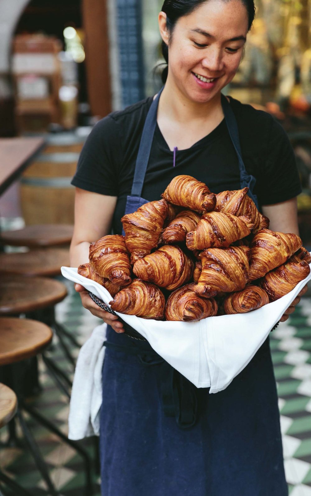 chef margarita manzke holding a tray of croissants at republique